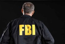 Person wearing jacket with FBI printed on back