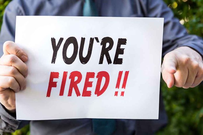 388134190 featured image Person holding YOURE FIRED sign