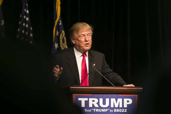 403318090 featured image Man speaking at podium with TRUMP sign