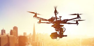 Drone flying over city at sunset time