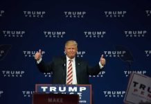 Person giving thumbs up at a political event