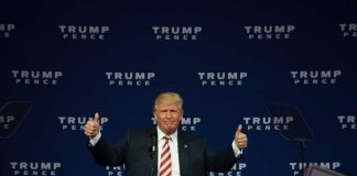 Person giving thumbs up at a political event