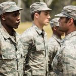 Military personnel standing in line outside during inspection