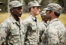 Military personnel standing in line outside during inspection