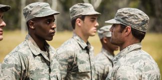 Military personnel standing in line outside during inspection