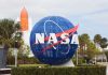 Blue NASA globe with rocket in background