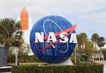 Blue NASA globe with rocket in background