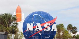 Blue NASA globe with rocket in background