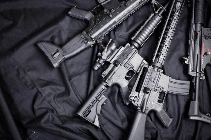 weapon_146886211 featured image Assault rifles arranged on a black fabric background