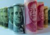 Rolled US dollar and Chinese yuan banknotes