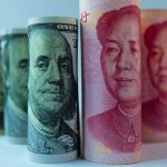 Rolled US dollar and Chinese yuan banknotes