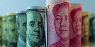 Rolled US dollar and Chinese yuan banknotes