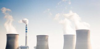 Four cooling towers of a power plant emitting steam