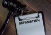 Gavel and clipboard with Defamation text
