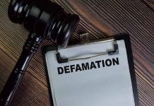 Gavel and clipboard with Defamation text