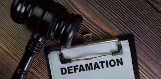 Gavel and clipboard with Defamation text