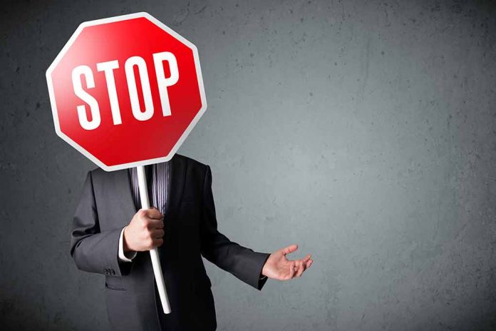 227442373 featured image Person holding a stop sign over their face