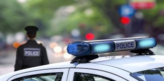 Police car and officer on a city street