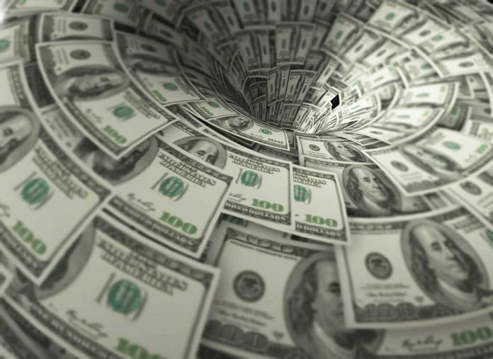 760572118 featured image Hundreddollar bills swirling into a financial vortex