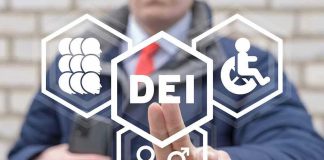 Person pointing at DEI symbols on glass
