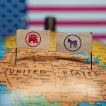 Republican and Democratic flags on USA map background