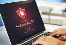 Laptop displaying fraud alert warning on screen
