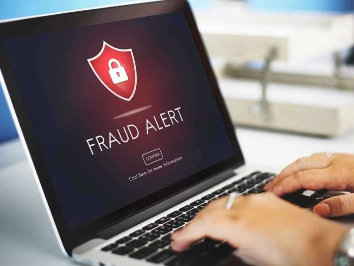412668235 Laptop displaying fraud alert warning on screen