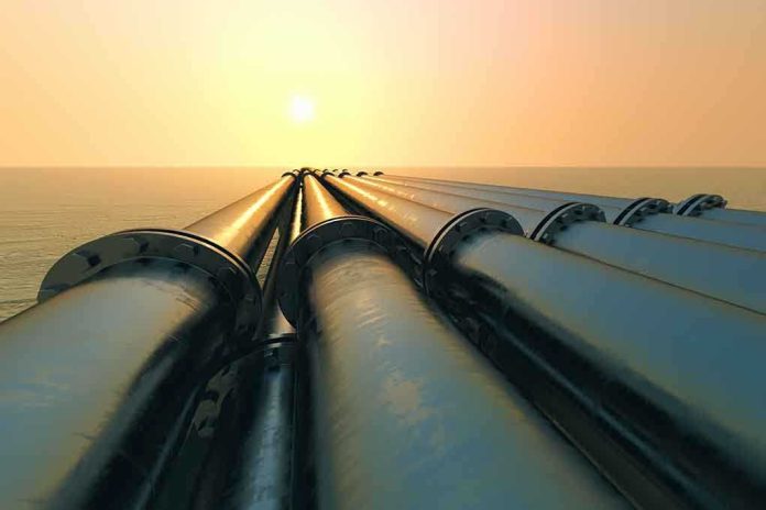 shutterstock_141093514.jpg Industrial pipes extending towards the horizon over water during sunset