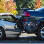 Two cars involved in a rear-end collision on a city street