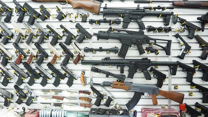 Wall display of various firearms in a store