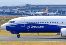 Boeing 737 800 on airport runway with other planes