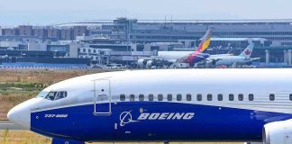 Boeing 737 800 on airport runway with other planes