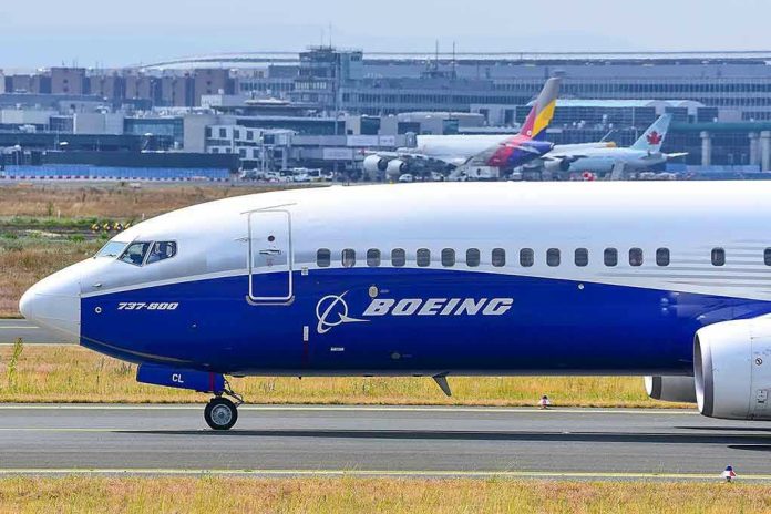 2406303801 Boeing 737 800 on airport runway with other planes