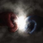 Red and blue boxing gloves clashing with smoke