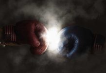 Red and blue boxing gloves clashing with smoke