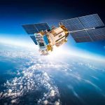 Satellite orbiting Earth with moon in background