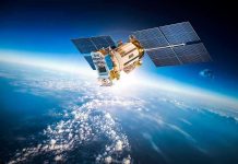 Satellite orbiting Earth with moon in background