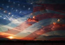A sunset with an overlay of the American flag and dramatic clouds