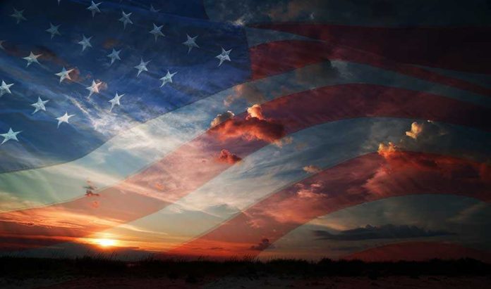 shutterstock_197253860.jpg A sunset with an overlay of the American flag and dramatic clouds