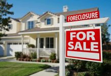 Foreclosure sign in front of a house for sale