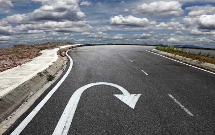 Curved road with a U-turn arrow marking.