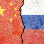 Chinese and Russian flags divided by a crack
