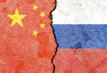 Chinese and Russian flags divided by a crack