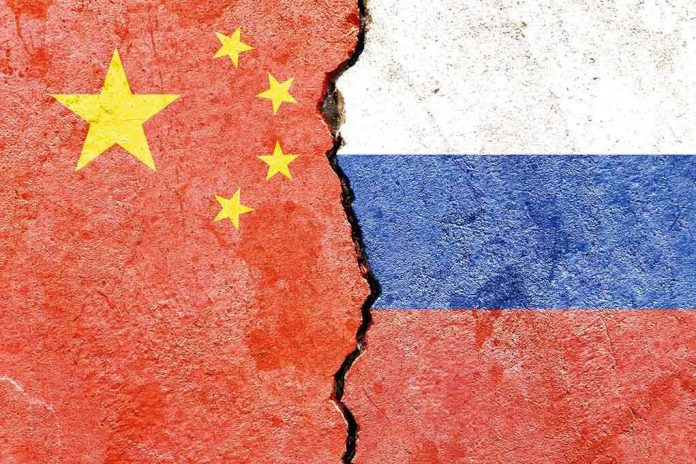 1888873300 Chinese and Russian flags divided by a crack