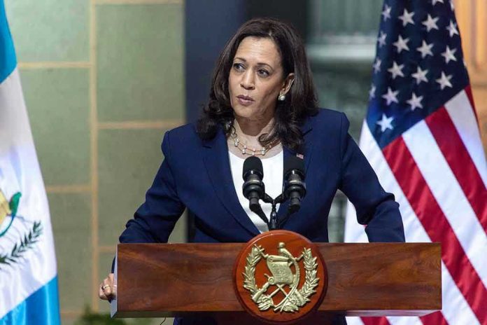 2183836501 Person speaking at podium with flags in background.