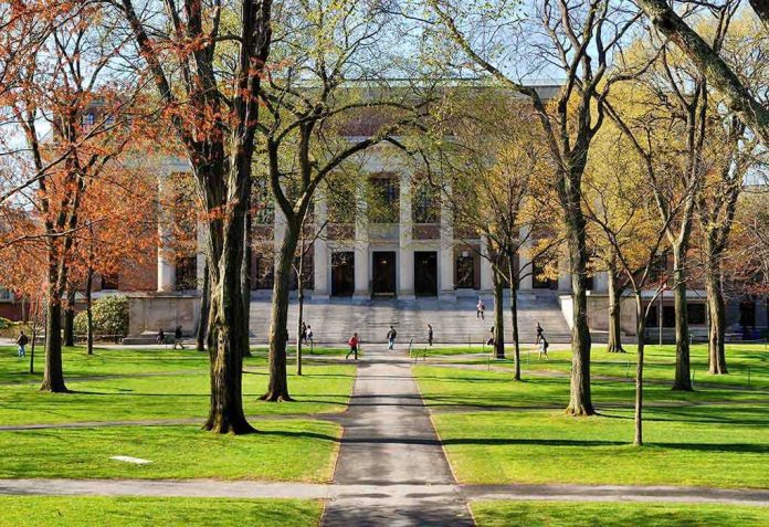 shutterstock_131270519.jpg Students walking on a university campus with autumn trees and a historic building in the background