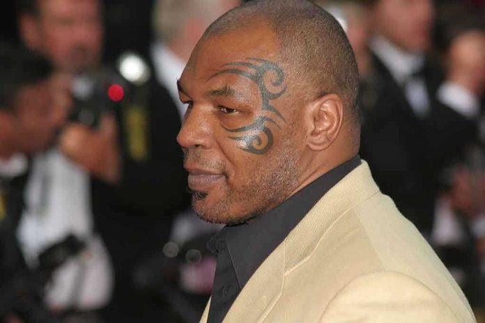 Profile of a man with a facial tattoo at a red carpet event