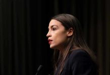 Person speaking at a podium side profile view