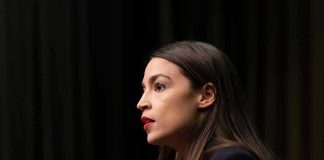 Person speaking at a podium side profile view