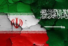 Cracked flags of Iran and Saudi Arabia.